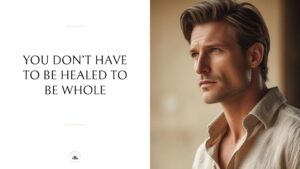 Man in beige shirt looking thoughtfully to the side in warm natural lighting