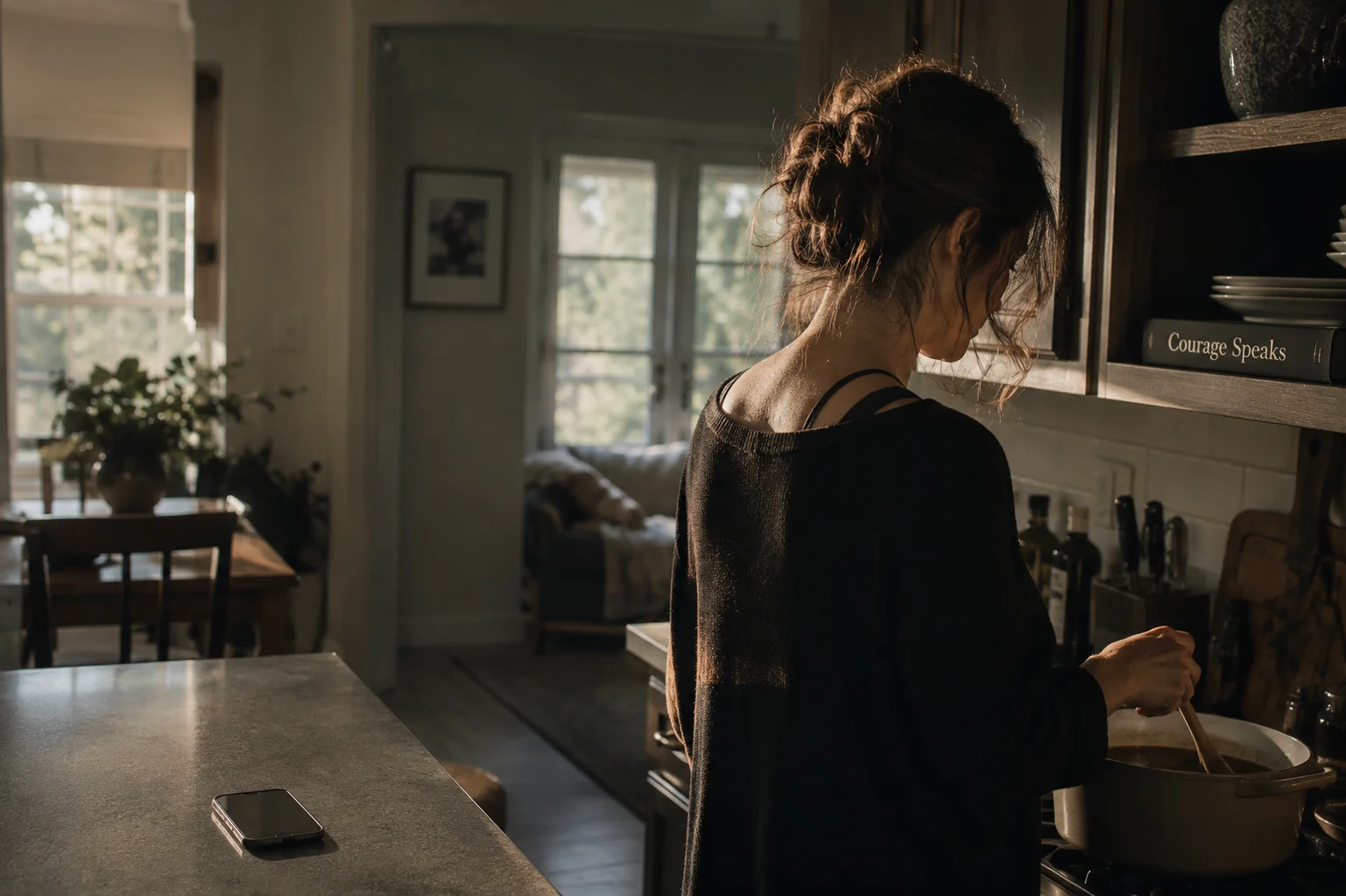 Woman calmly cooking dinner at her stove, a picture of how therapy works so quietly in daily life.